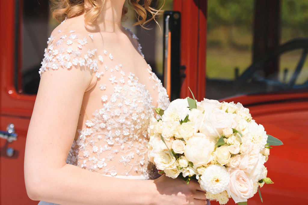 Bride in lace wedding dress and flowers