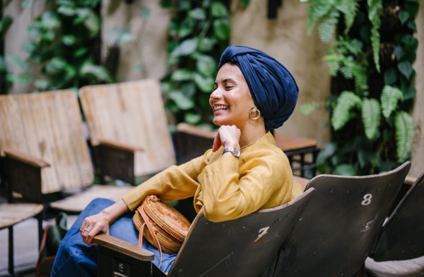 a woman with headwrap smiling